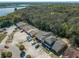 Aerial view of townhome community with parking and mature trees, near a lake at 1248 Woodman Way, Orlando, FL 32818