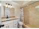 Bathroom with granite countertop vanity and tiled shower with nautical curtain at 1248 Woodman Way, Orlando, FL 32818