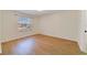 Bright bedroom featuring wood-look flooring and a window letting in natural light at 1248 Woodman Way, Orlando, FL 32818