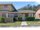 Charming townhome featuring a well-manicured lawn and inviting front entrance at 1248 Woodman Way, Orlando, FL 32818