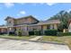 Townhouse with brick facade, landscaped front yard, and designated parking at 1248 Woodman Way, Orlando, FL 32818