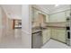 Well-lit kitchen with stainless steel appliances and a view into the living room at 1248 Woodman Way, Orlando, FL 32818