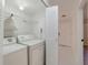 Laundry room with washer, dryer, shelving, and bi-fold door at 1248 Woodman Way, Orlando, FL 32818