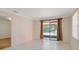 Bright living room featuring tiled floor and sliding glass door to the backyard at 1248 Woodman Way, Orlando, FL 32818