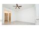 Neutral bedroom with a ceiling fan, tile floor and a door leading to a bathroom at 13283 Sw 30Th Terrace Rd, Ocala, FL 34473