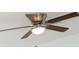 Close-up of a brown ceiling fan with four blades and a light fixture in the center at 13283 Sw 30Th Terrace Rd, Ocala, FL 34473