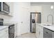 Modern kitchen featuring stainless steel appliances, white cabinetry, and stylish countertops and lighting at 13283 Sw 30Th Terrace Rd, Ocala, FL 34473