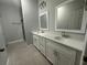 Modern bathroom featuring double vanity with quartz countertops and tiled floors at 13745 Sw 43Rd Cir, Ocala, FL 34473