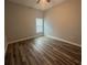 An empty bedroom featuring a ceiling fan, a window, and wood-look flooring at 13745 Sw 43Rd Cir, Ocala, FL 34473