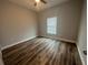 A standard bedroom with a ceiling fan, a single window, and laminated wood flooring at 13745 Sw 43Rd Cir, Ocala, FL 34473