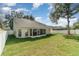 Spacious backyard featuring a screened-in porch, lush lawn, and secure fencing at 1428 Oberlin Ter, Lake Mary, FL 32746