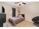 Bedroom with a ceiling fan, a window, and dark furniture, ideal for a  at 1428 Oberlin Ter, Lake Mary, FL 32746