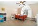 Cozy bedroom with vaulted ceiling, large window, white furniture, and carpeted flooring at 1428 Oberlin Ter, Lake Mary, FL 32746