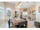 Inviting dining room features a wooden table, tile floors, and decorative light fixture at 1428 Oberlin Ter, Lake Mary, FL 32746