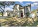 Two-story home featuring an arched entryway, lush landscaping, and a well-maintained lawn, exuding charm and curb appeal at 1428 Oberlin Ter, Lake Mary, FL 32746