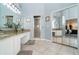 An airy main bathroom featuring dual sinks, granite countertops, and a large mirror closet at 1428 Oberlin Ter, Lake Mary, FL 32746