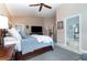 Spacious main bedroom with large bed, ceiling fan and connecting door to the main bathroom at 1428 Oberlin Ter, Lake Mary, FL 32746