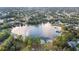 A picturesque aerial shot of a lake surrounded by lush greenery and charming homes at 1456 Helena Ct, Deltona, FL 32725