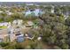 Aerial view of a home situated on a lush, wooded lot in a quiet, residential neighborhood near a lake at 1456 Helena Ct, Deltona, FL 32725