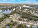 A scenic aerial view highlighting a tranquil lake community surrounded by lush trees and homes at 1456 Helena Ct, Deltona, FL 32725