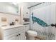 Cozy bathroom featuring white cabinets, a vanity, and a shower with a peacock-themed curtain at 1456 Helena Ct, Deltona, FL 32725