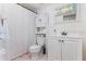 Cozy bathroom featuring white cabinets, a vanity, and a shower with a stylish curtain at 1456 Helena Ct, Deltona, FL 32725