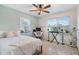 Bedroom featuring a ceiling fan, natural light, and functional workspace at 1456 Helena Ct, Deltona, FL 32725