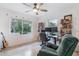 Comfortable bedroom featuring a ceiling fan, natural light, and functional workspace at 1456 Helena Ct, Deltona, FL 32725