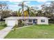 Charming single-story home featuring lush landscaping, a well-manicured lawn, and a welcoming blue front door at 1456 Helena Ct, Deltona, FL 32725