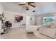 Cozy living area featuring modern decor, a wall-mounted TV, and abundant natural light through a large window at 1456 Helena Ct, Deltona, FL 32725