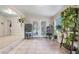 Bright sunroom with tile floor, white walls, windows, and plants at 1456 Helena Ct, Deltona, FL 32725