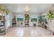 Bright sunroom with tile floor, white walls, windows, and plants at 1456 Helena Ct, Deltona, FL 32725