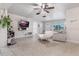 Cozy living room with neutral tones, tile floors, ceiling fan, and lots of light at 1456 Helena Ct, Deltona, FL 32725