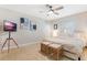 Bright main bedroom offering a ceiling fan, natural light, and a sleek entertainment system at 1456 Helena Ct, Deltona, FL 32725