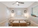 Bright main bedroom featuring a ceiling fan, natural light, and stylish wicker bench at 1456 Helena Ct, Deltona, FL 32725