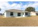 Spacious backyard with a patio and sliding glass doors leading into the house at 15204 Margaux Dr, Clermont, FL 34714