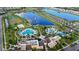 Aerial view showcasing the community amenities including pools, a lake with a fountain, and lush landscaping at 1547 Carey Palm Cir, Kissimmee, FL 34747