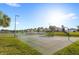 Outdoor basketball court featuring a well-maintained surface, basketball hoops, and surrounded by green grass at 1547 Carey Palm Cir, Kissimmee, FL 34747