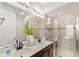 Modern bathroom featuring dual sinks, a glass-enclosed shower, and contemporary fixtures and finishes at 1547 Carey Palm Cir, Kissimmee, FL 34747