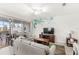 Bright living room with sliding glass doors to the screened-in porch at 1547 Carey Palm Cir, Kissimmee, FL 34747