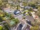 High angle neighborhood view with manicured landscaping, mature trees, and clear blue swimming pools at 1585 Chestnut Ave, Winter Park, FL 32789