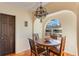 Cozy breakfast nook featuring a round table, arched window, and unique chandelier at 1585 Chestnut Ave, Winter Park, FL 32789