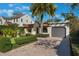 Inviting single-story home with lush landscaping, brick driveway, and a cozy front yard at 1585 Chestnut Ave, Winter Park, FL 32789