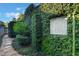 Beautiful lush landscaping featuring vine-covered walls and stone accents creating a serene outdoor space at 1585 Chestnut Ave, Winter Park, FL 32789