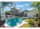 Backyard pool and spa with mature landscaping, creating a private and luxurious outdoor space at 1585 Chestnut Ave, Winter Park, FL 32789