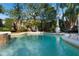 Refreshing pool area with a serene water fountain surrounded by lush landscaping and comfortable seating at 1585 Chestnut Ave, Winter Park, FL 32789