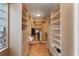 Well-organized walk-in closet with built-in shelving, drawers, and shoe racks at 1585 Chestnut Ave, Winter Park, FL 32789