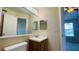 Bathroom with vanity, large mirror, and adjacent room with a shower/tub combo at 1932 Lake Atriums Cir # 74, Orlando, FL 32839