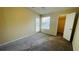 Bedroom featuring carpet, a ceiling fan, and a window to the backyard at 1932 Lake Atriums Cir # 74, Orlando, FL 32839