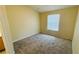 A sunlit bedroom with neutral walls and plush carpeting at 1932 Lake Atriums Cir # 74, Orlando, FL 32839